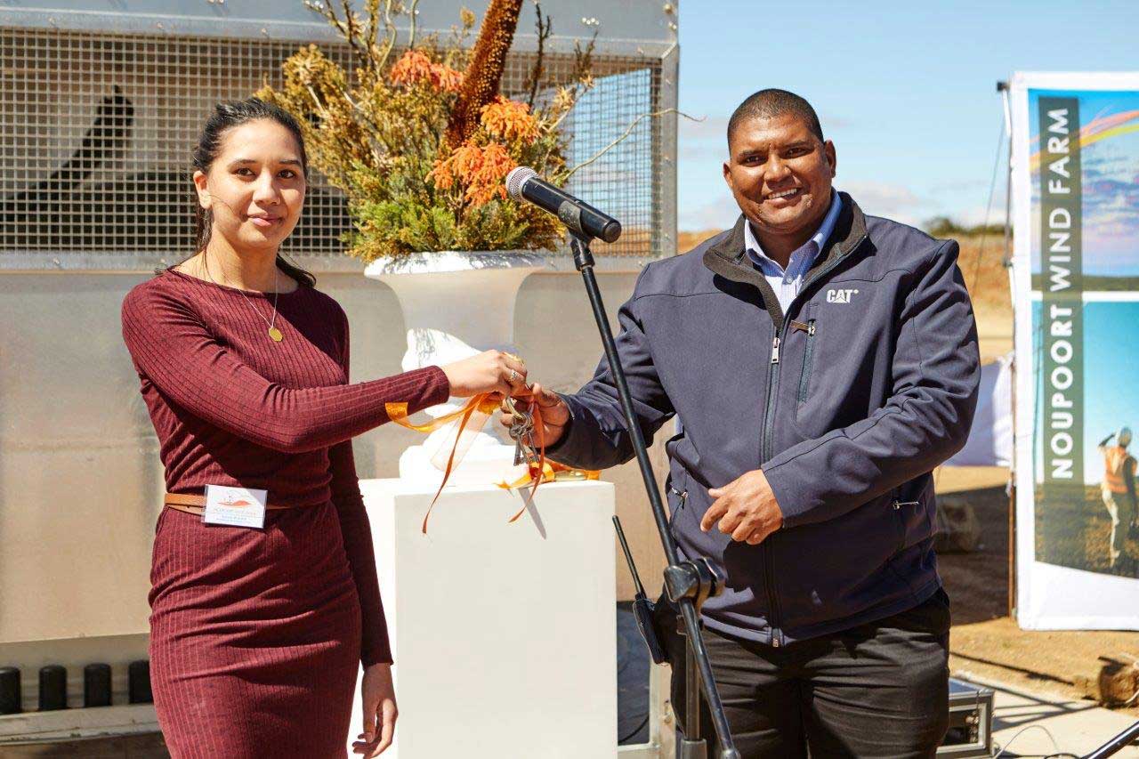 Mainstream Assistant Project Manager Aniqah Misbach hands the key to Noupoort Wind Farm to Plant Manager Dennis Solomon
