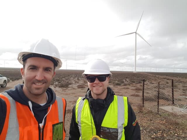 mainstream workers in front of Khobab wind turbines