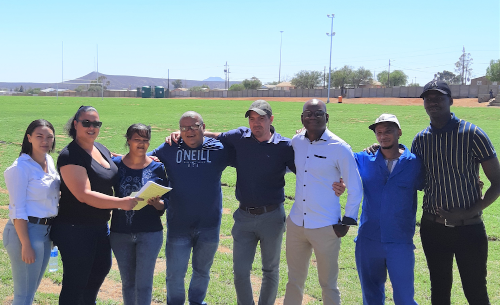 Mainstream's Anchel Opperman and Gwynne-Lee Borcherds, left, hand over the upgraded sports field to local council official Johanna Koose and her team