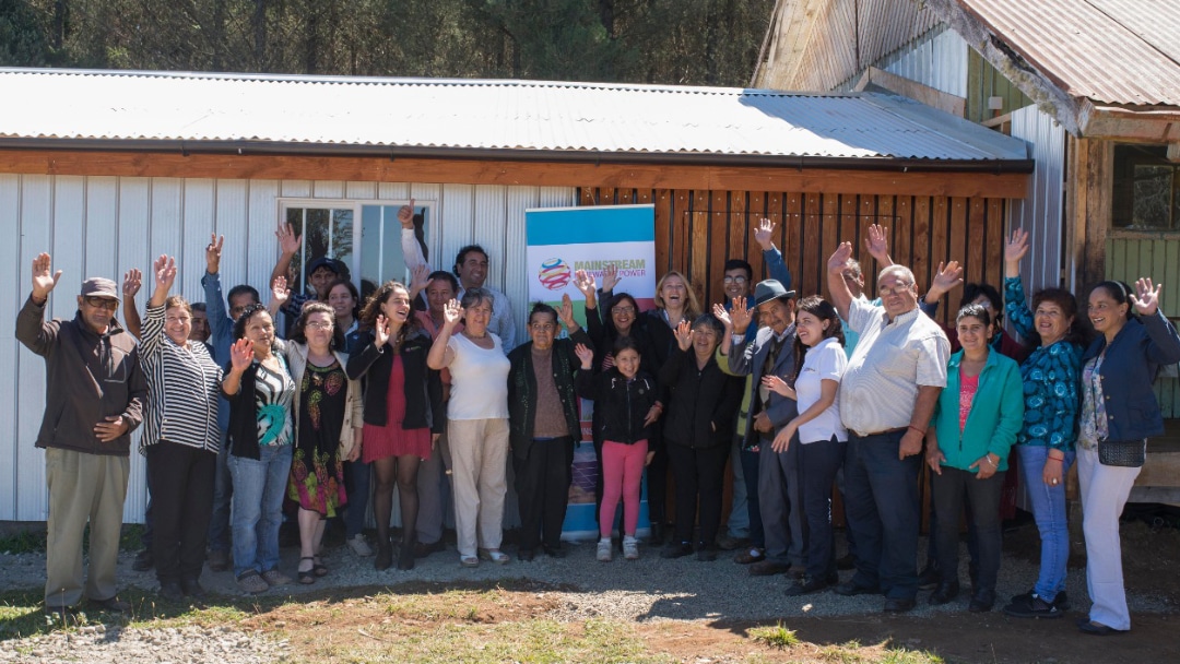 Community members cheer opening of clubhouse behind them