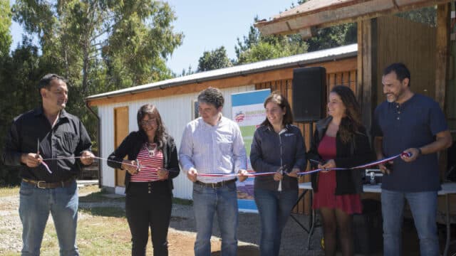 community leaders and mainstream renewable energy staff cut ribbon on new clubhouse extension