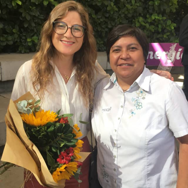 Fernanda holds bouquet and poses with Marcela