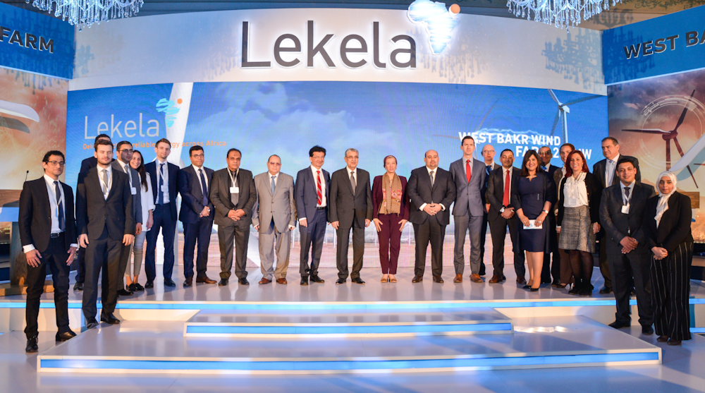 Ministers and Government Officials standing in a line on stage facing the camera posing for a picture.