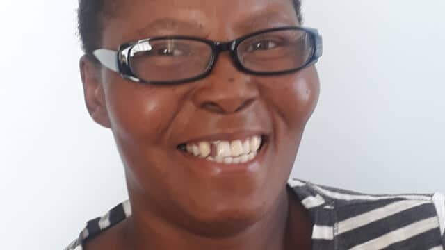 close up photo of Martha wearing glasses in striped top