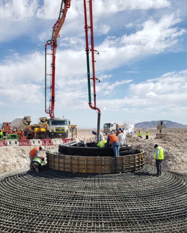 Concrete pours into turbine foundation from overhead crane arm