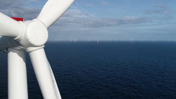 nacelle of wind turbine against sea scene