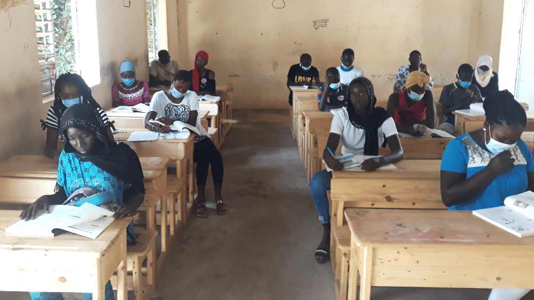 School pupils sit at desks built from turbine crates