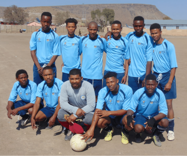 group photo of players in blue team strip