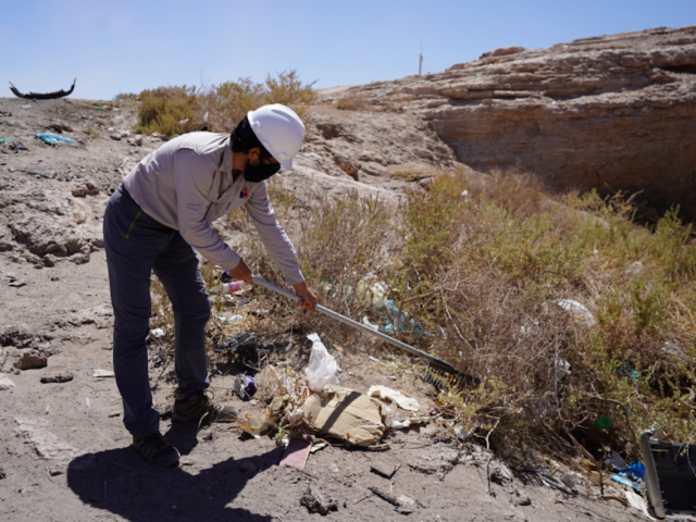 volunteers armed with rakes clearing up rubbish