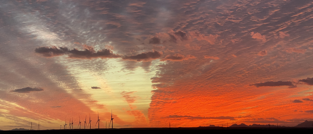 orange clouds from sunset over west bakr wind farm