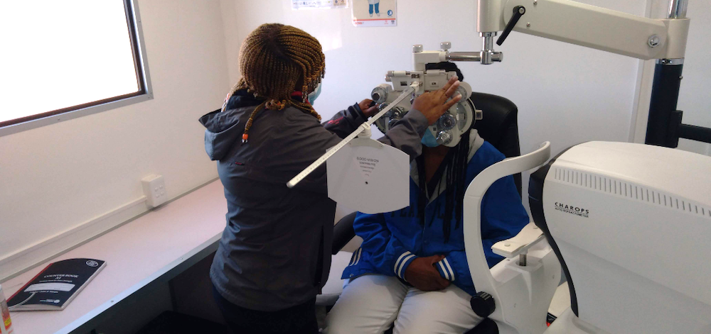 Optician checks patient's eye sight