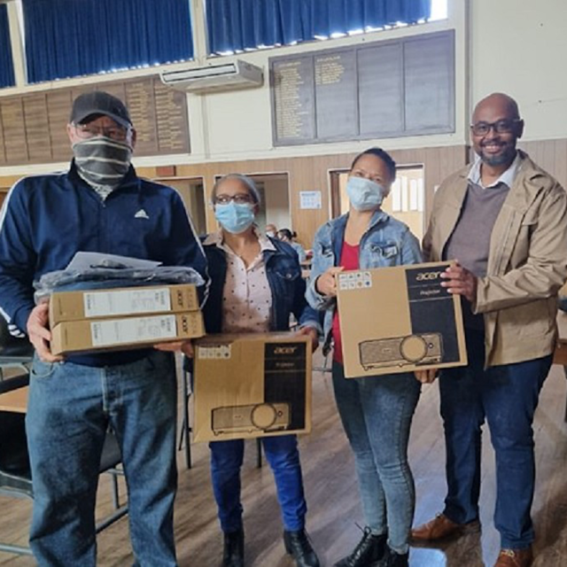 Teachers taking delivery of computer projectors in a hi-school