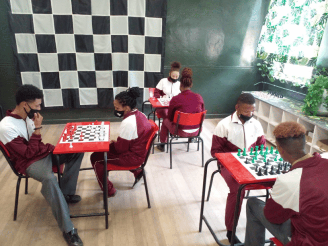 School pupils playing chess while wearnig Covid masks