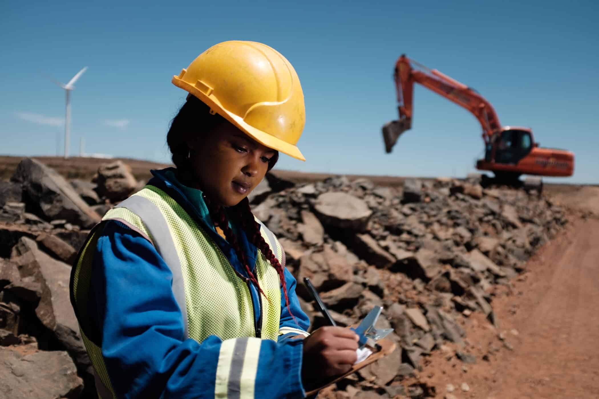 woman in protective equipment on a construction site - mainstream renewable power global development standard