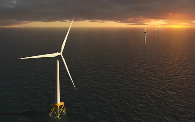 3D rendered image of a line of floating offshore wind turbine with sun setting over ocean