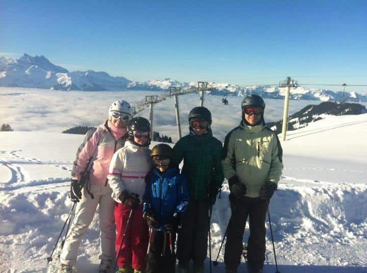 Randal's family in ski gear against snowy backdrop