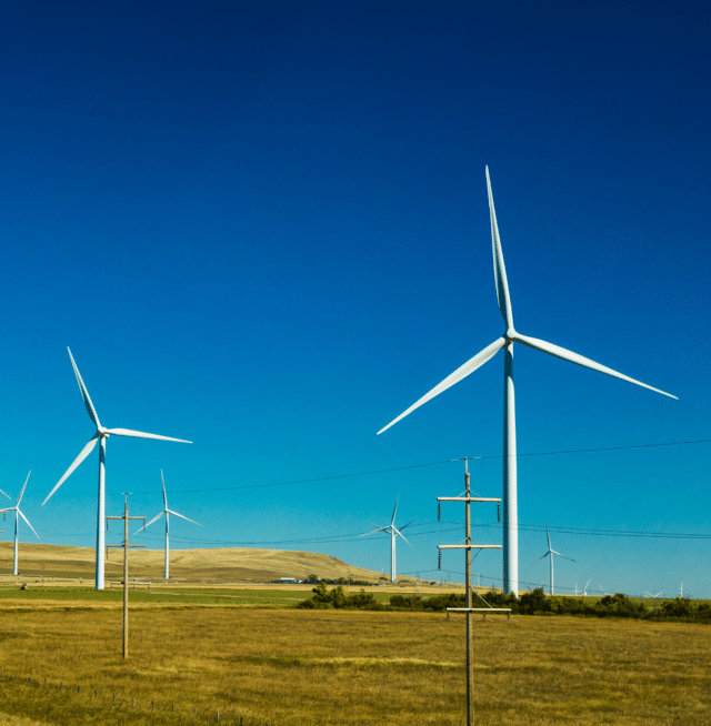 Onshore wind turbines with farmland surrounding - Planet Positive Impact - Mainstream Renewable Energy - Sustainability Report 2022