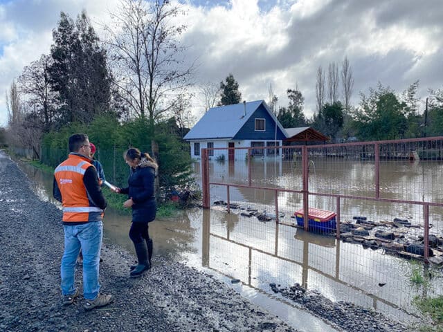 Mainstream staff survey flooded home in a neighbouring community