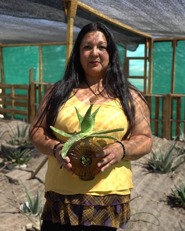 Female indigenous entrepreneur holding aloe vera product